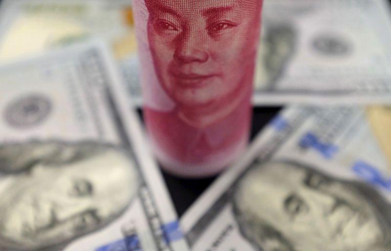 FILE PHOTO: Benjamin Franklin U.S. 100 dollar banknotes and a Chinese 100 yuan banknote with the late Chinese Chairman Mao Zedong are seen in this file picture illustration in Beijing, China, January 21, 2016. REUTERS/Jason Lee/File Photo FILE PHOTO: Benjamin Franklin U.S. 100 dollar banknotes and a Chinese 100 yuan banknote with the late Chinese Chairman Mao Zedong are seen in this file picture illustration in Beijing, China, January 21, 2016. REUTERS/Jason Lee/File Photo